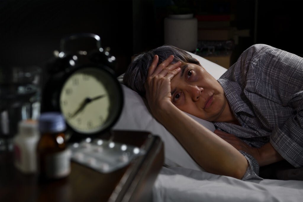 woman lying in bed cannot sleep from insomnia