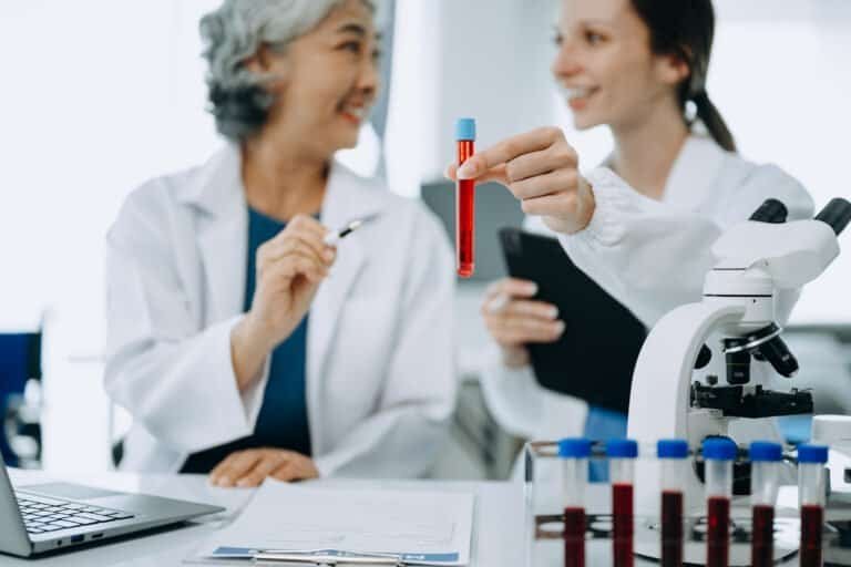 Scientist team meeting and writing analysis results in the laboratory study and analyze scientific sample. griculture, research and scientists with online reading, test