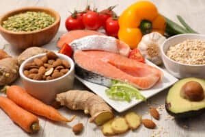 Assortment product of rich in antioxidants and vitamins sources on white wooden background